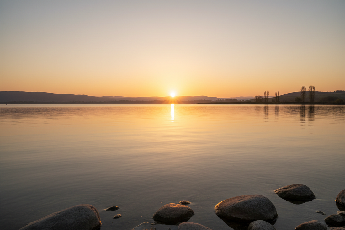 Inspirational recovery quotes - golden sunrise over a calm lake representing hope and healing in sobriety